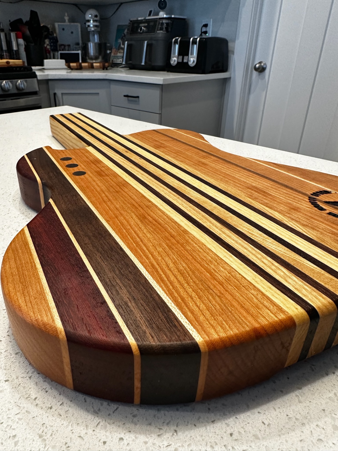 Guitar-shaped handcrafted serving board by The Knotty Otter