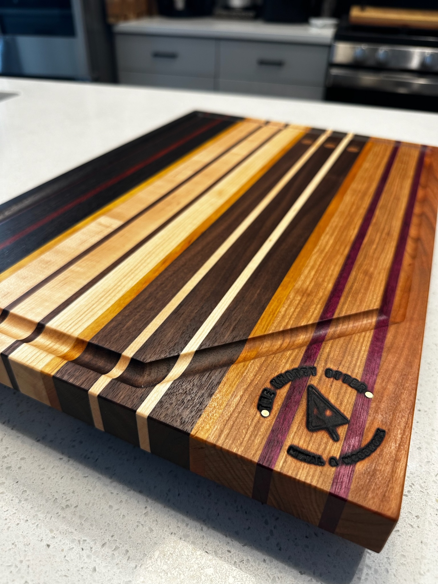 Striped handcrafted cutting board with branded detail